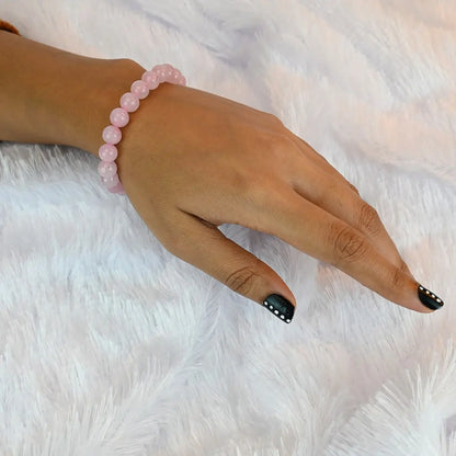 Woman wearing Vrishta Rose Quartz Bracelet on wrist