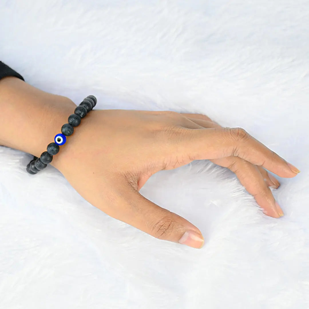 Woman wearing Vrishta Natural Evil Eye Bracelet on wrist for style and protection