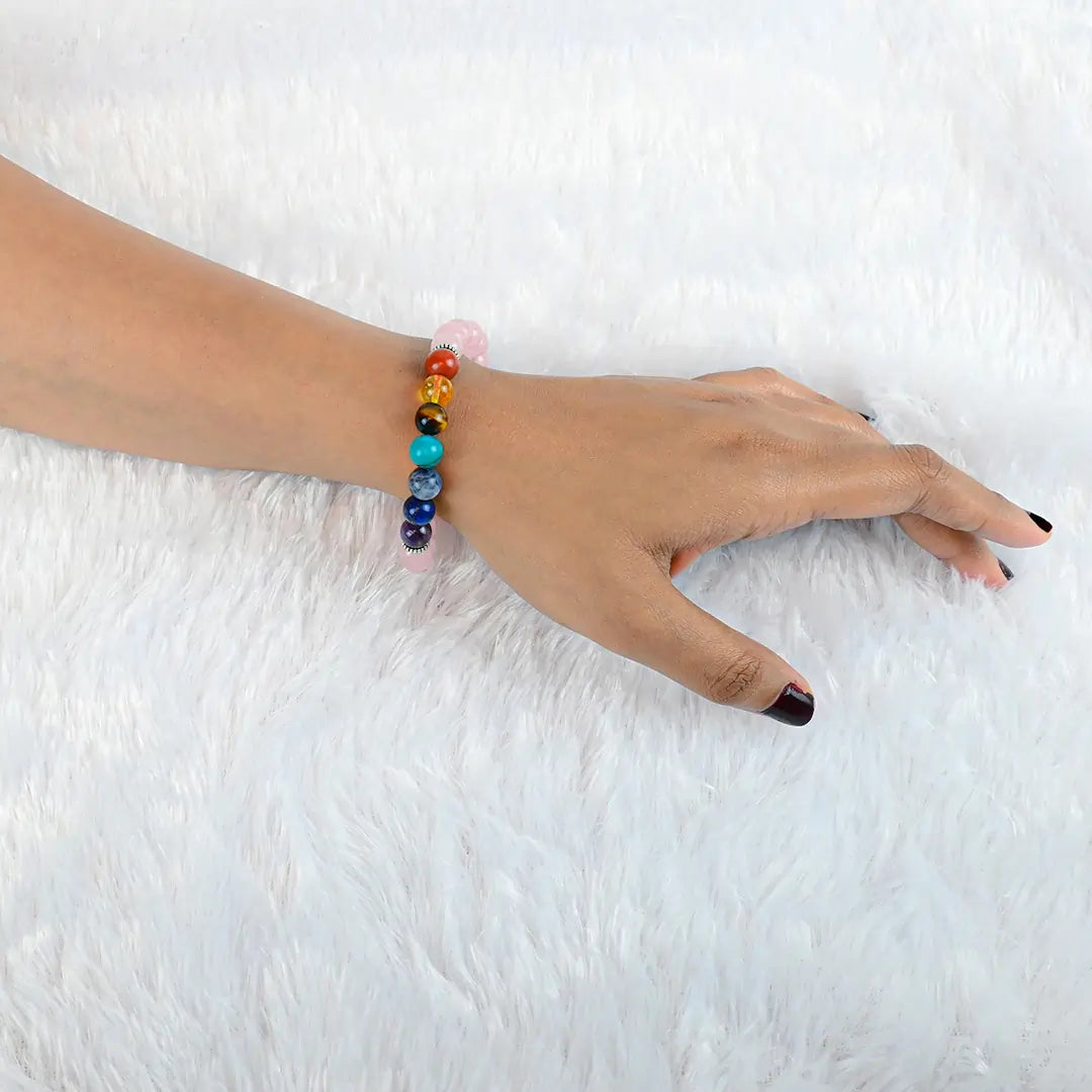 Woman wearing Vrishta 7 Chakra Rose Quartz Bracelet on wrist